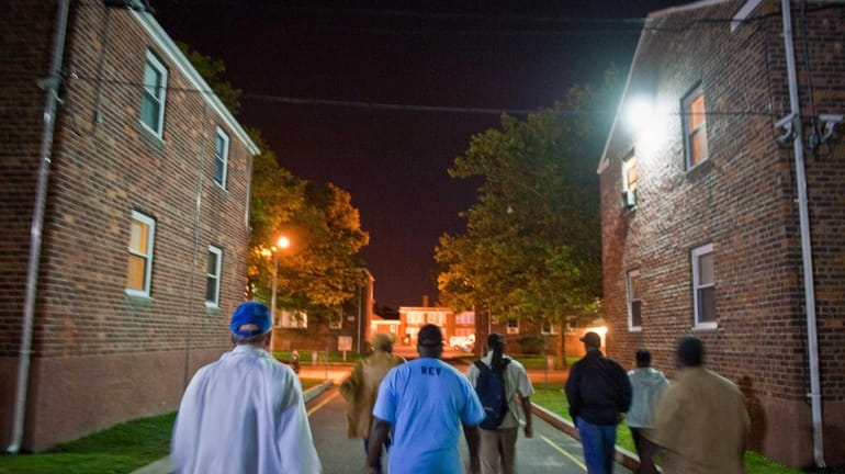 Activists march through a Hempstead Village neighborhood plagued by drugs...
