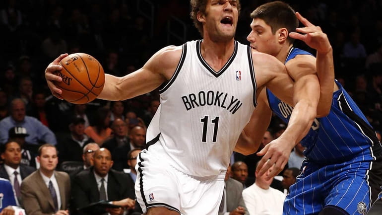 Brook Lopez of the Nets drives to the hoop in...
