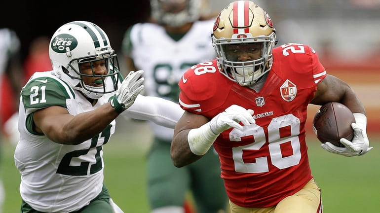 Jets safety Marcus Gilchrist chases San Francisco 49ers running back...