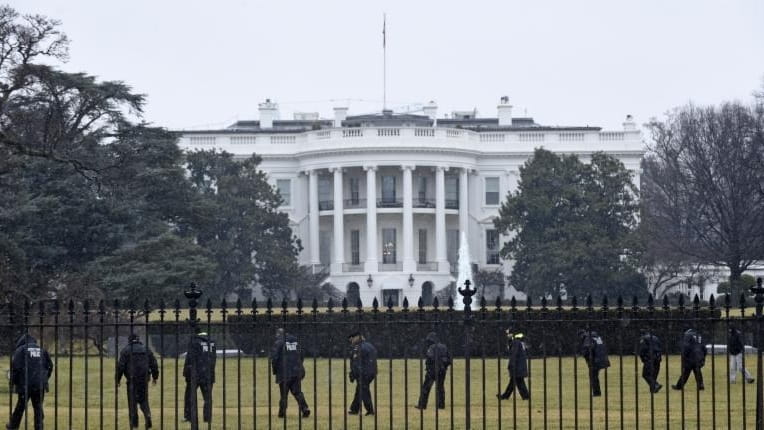 Secret Service officers search the south grounds of the White...