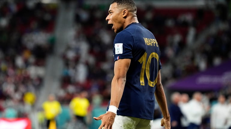 France's Kylian Mbappe celebrates scoring his side's third goal during...