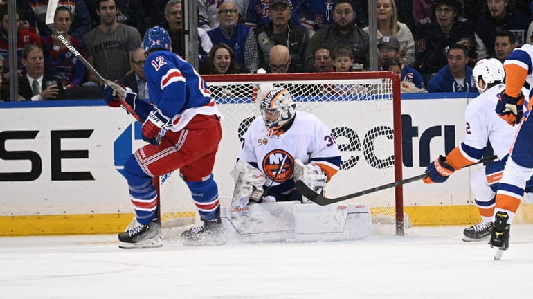 Rangers right wing Julien Gauthier scores past New York Islanders...