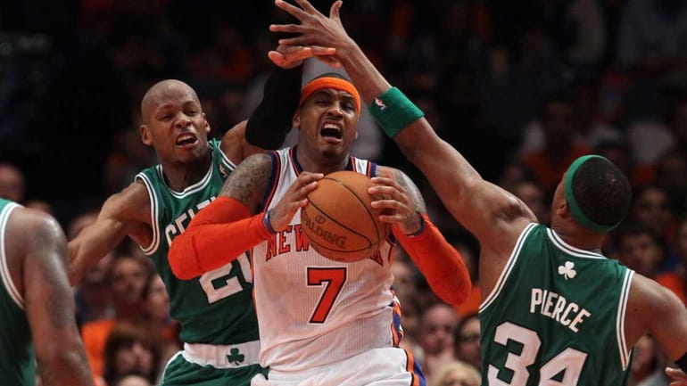 Carmelo Anthony battles for the ball against Ray Allen and...