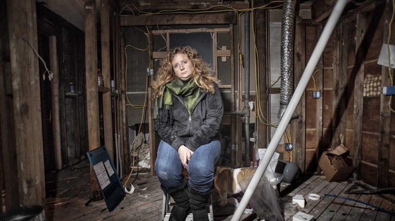 Amy Italiano sits in her gutted home in the Nassau...