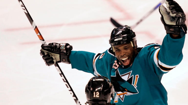 FILE - San Jose Sharks' Mike Grier, top, celebrates with...