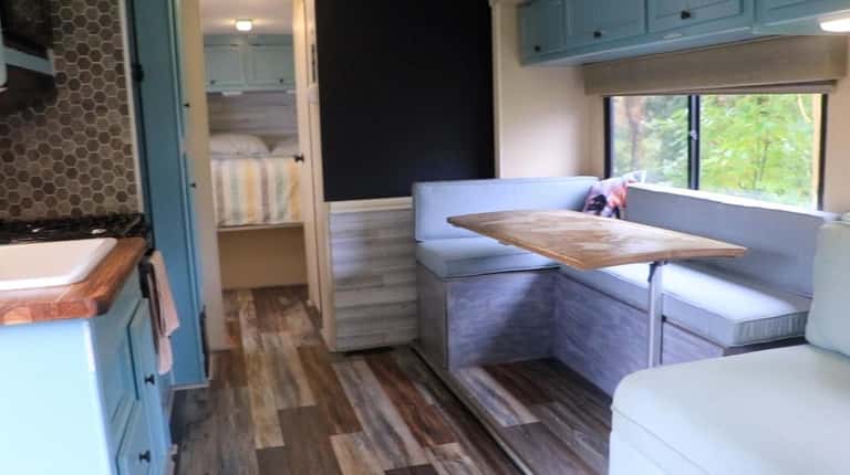 The 300-square-foot RV has a kitchen, bathroom, shower, bedroom, dining...