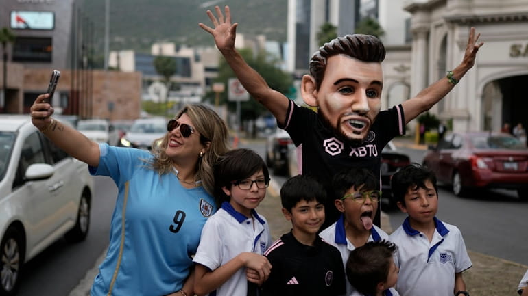 Fans of soccer star Lionel Messi wait for the arrival...