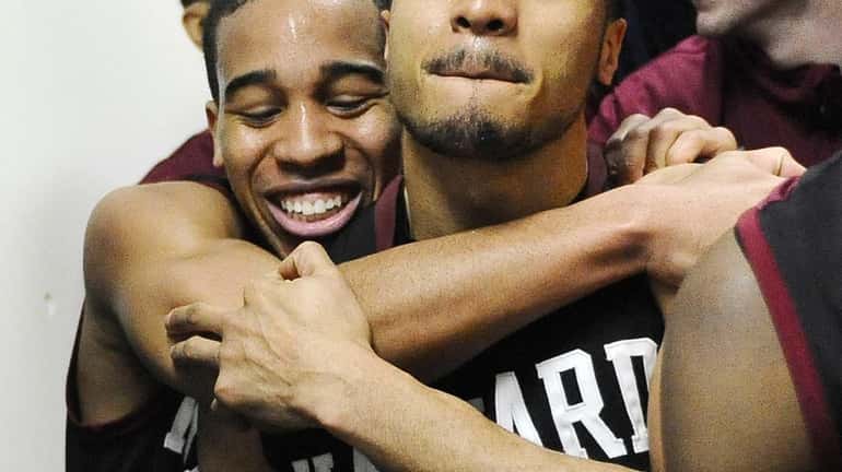 Harvard's Siyani Chambers, left, and Brandyn Curry, right, embrace in...