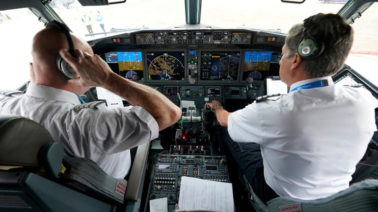 American Airlines pilot captain Pete Gamble, left, and first officer...
