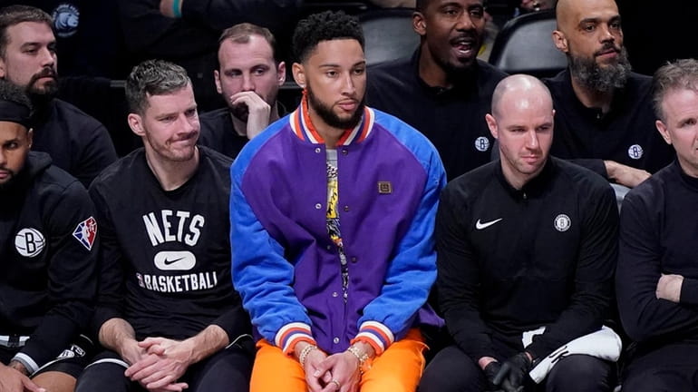 Brooklyn Nets' Ben Simmons, center, sits on the bench during...