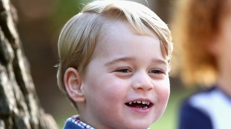 Prince George plays with bubbles at a children's party for...