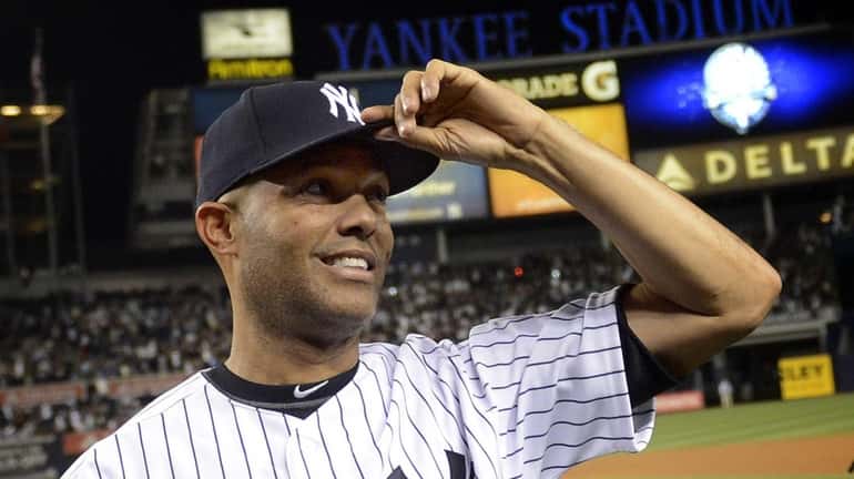 Yankees pitcher Mariano Rivera tips his cap to the fans...
