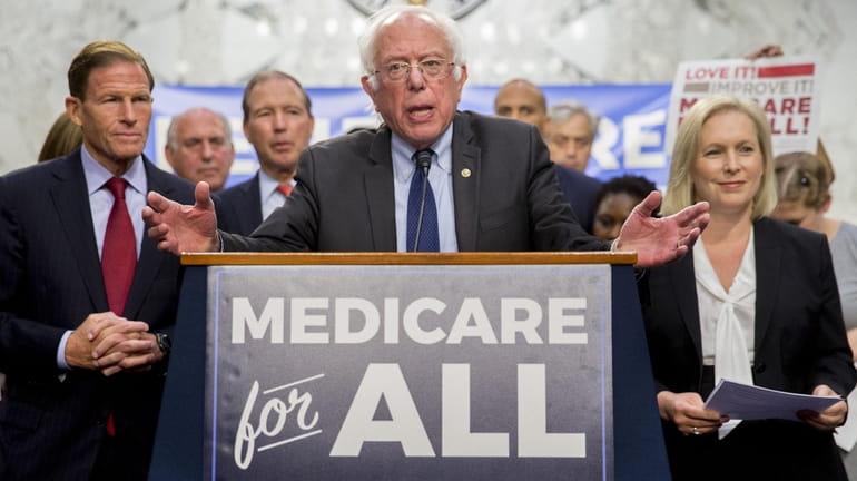 Sen. Bernie Sanders speaks during a health care bill news conference...