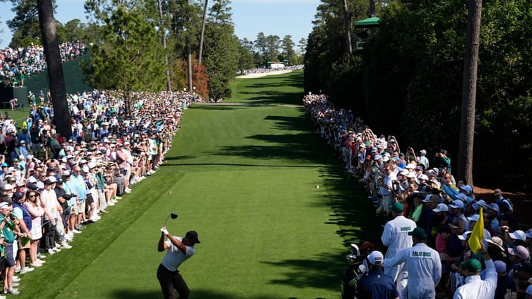 Tiger Woods tees off on the 18th hole during a...