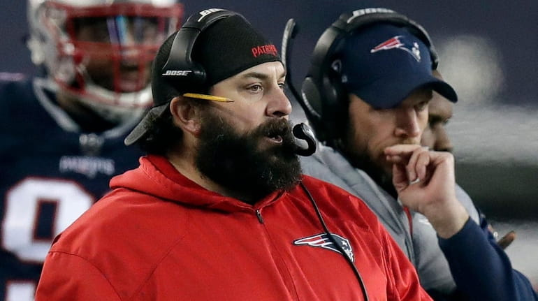 New England Patriots defensive coordinator Matt Patricia watches from the...