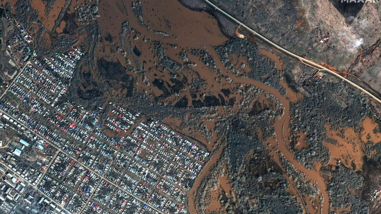 This image provided by Maxar Technologies, shows flooded areas in...