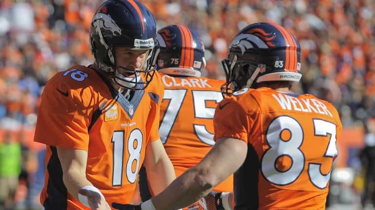 Denver Broncos quarterback Peyton Manning (18) congratulates wide receiver Wes...