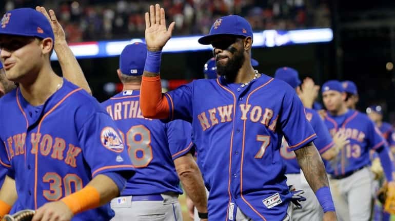 New York Mets' Michael Conforto and Jose Reyes celebrate with...