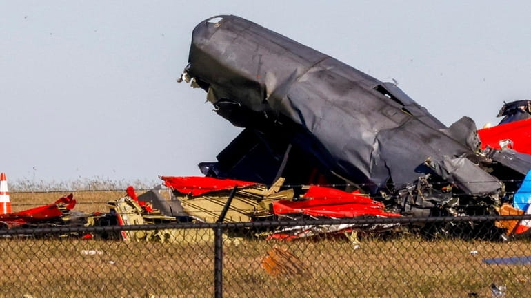 Investigators in Texas survey damage from Saturday's mid-air collision during...
