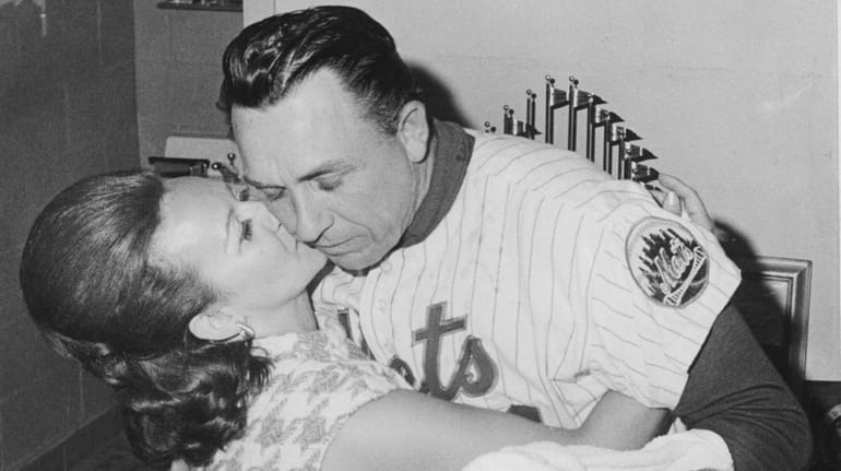 Mets manager Gil Hodges gets a kiss from his wife...