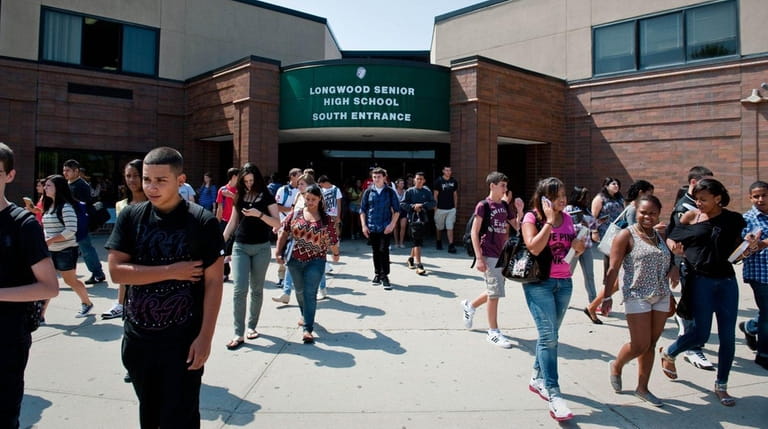 Longwood High School students leave the building after starting classes...