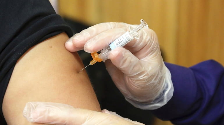 A flu vaccine is administered at the Brownsville Events Center...