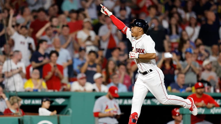 Boston Red Sox's Enmanuel Valdez celebrates his solo home run...