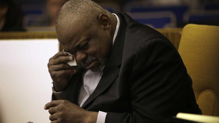 Grafton Peterson, father of the late Erin Peterson wipes away...