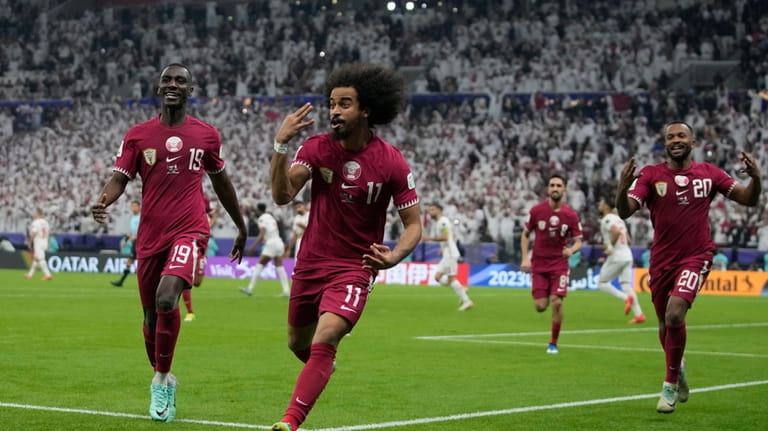 Qatar's Akram Afif celebrates after scoring his third goal during...