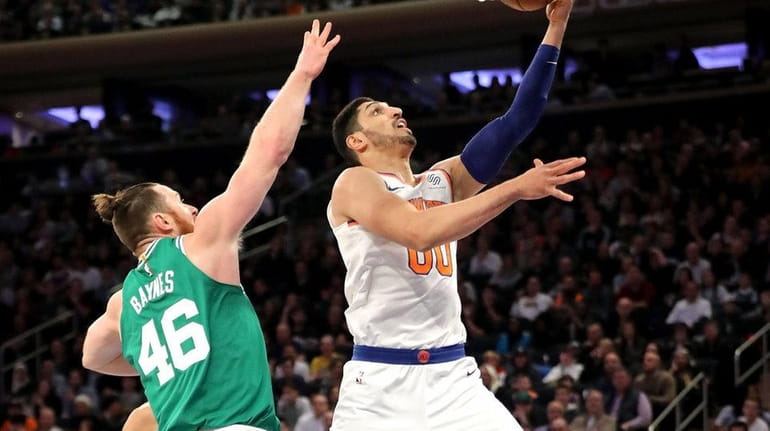 Enes Kanter drives past Celtics' Aron Baynes in the first...