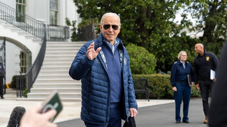 President Joe Biden waves as he walks to Marine One...