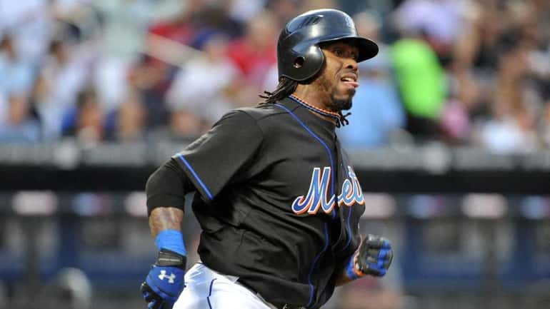 Mets shortstop Jose Reyes rounds first base after connecting for...