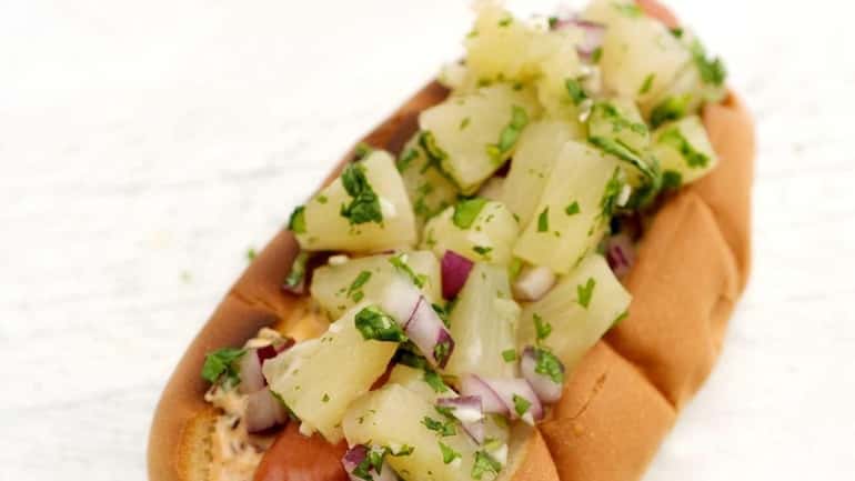 A hot dog with pineapple salsa and chipotle mayonnaise. (June...