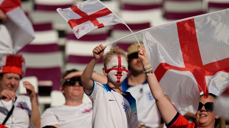 Fans wave England flags prior to the start of the...
