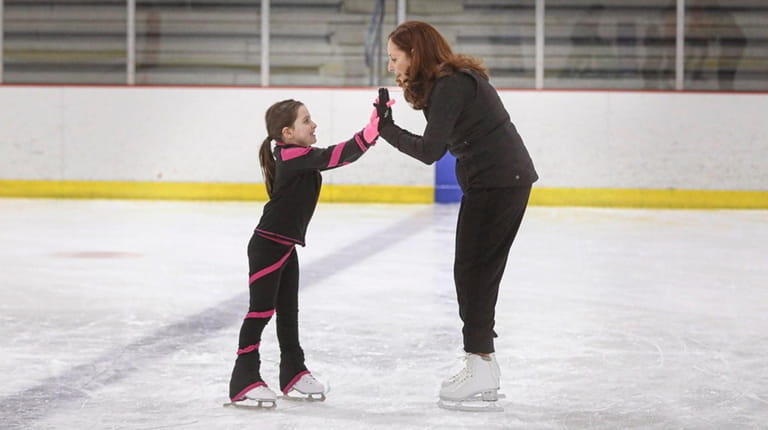 Hope Silverman shares a moment with Mila Molino, 6, during the...
