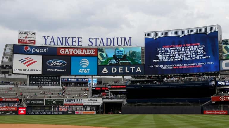 The scoreboard is seen announcing the game between the Yankees...