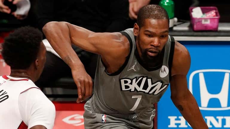 Kevin Durant of the Nets controls the ball during the first...