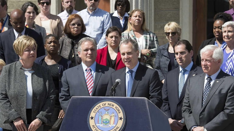 State Attorney General Eric Schneiderman speaks at a press conference...