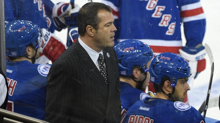 New York Rangers head coach Alain Vigneault looks on against...