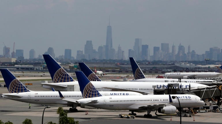 United Airlines jets are parked on the tarmac at Newark...