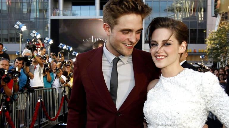Robert Pattinson, left, and Kristen Stewart arrive at the premiere...
