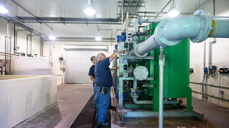 Water plant operators Joe Barbarito, left, and Richard Zimbardi work at...