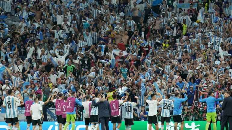 Argentinian players acknowledge fans after winning the World Cup group...