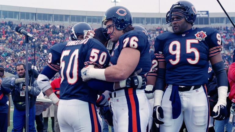 Chicago Bears nine-time Pro Bowler Mike Singletary (50) gets a...