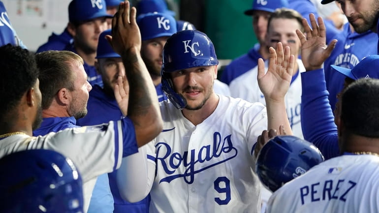 Kansas City Royals' Vinnie Pasquantino (9) is congratulated after he...