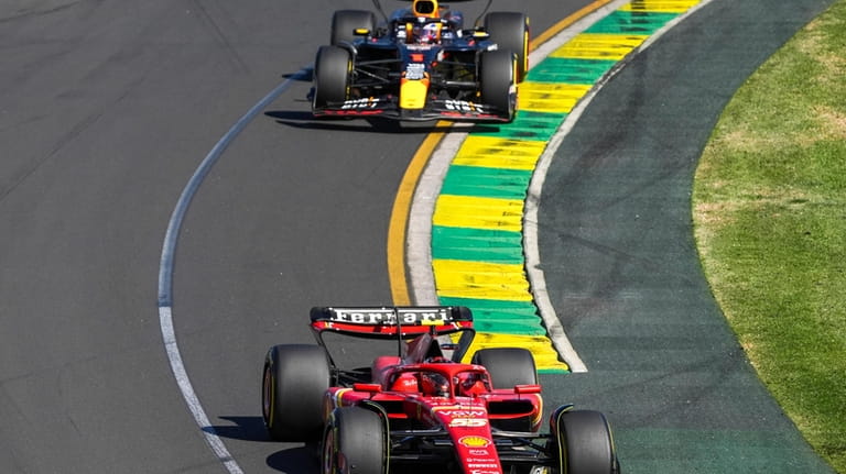 Ferrari driver Carlos Sainz of Spain leads Red Bull driver...