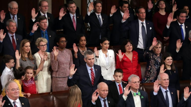 Members of the House of Representatives take their oath of...
