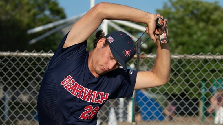 Harwich pitcher Cameron Mayer, from Syosset, warms up before a...