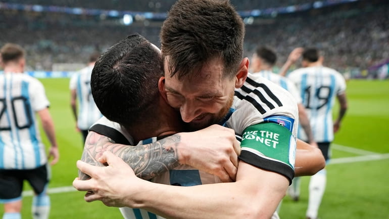 Argentina's Lionel Messi, right, celebrates with his teammate Angel Di...