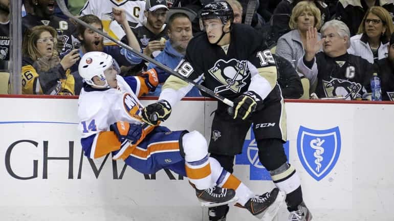 Pittsburgh Penguins' Beau Bennett collides with Islanders' Thomas Hickey in...